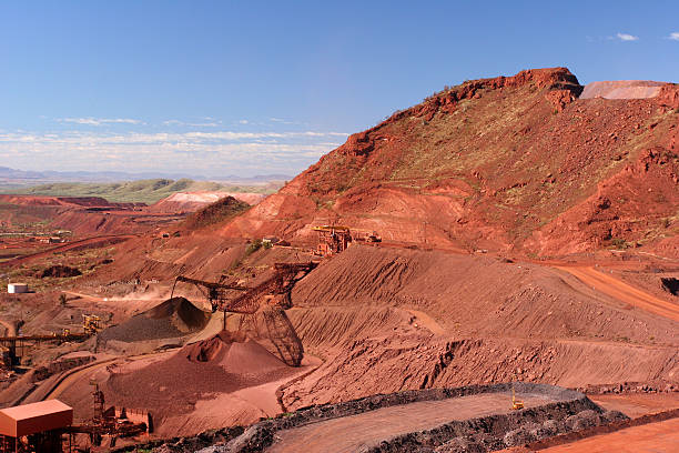 Iron Ore Truck Unloading Western Australia Iron Ore Truck Unloading, Conveyor and Stockpile in mine at the Hamersley Ranges Pilbara Western Australia the pilbara stock pictures, royalty-free photos & images