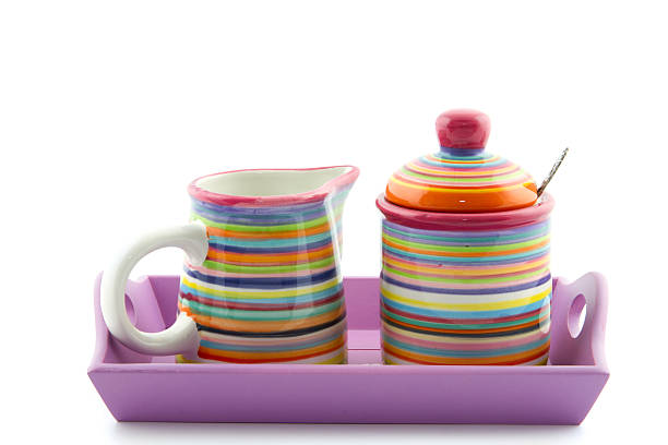 striped  milk jug and sugar bowl on a violet serving-tray