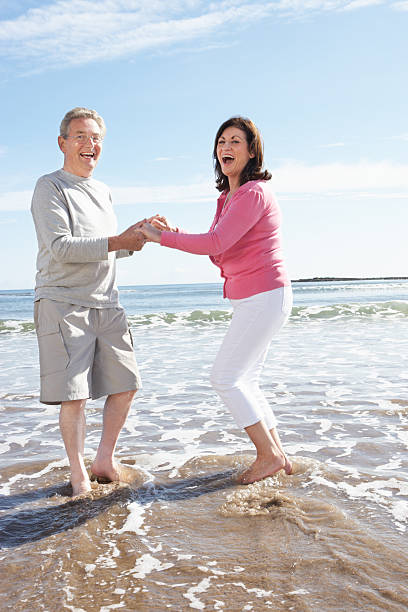 istock Senior Couple Having Fun On Beach Holiday 465291299