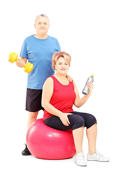 istock Mature man and woman posing with exercising equipment 465291721