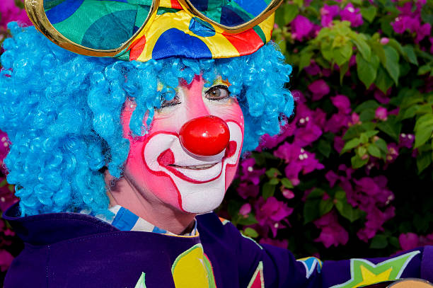istock Clown with guitar in the park 465292256