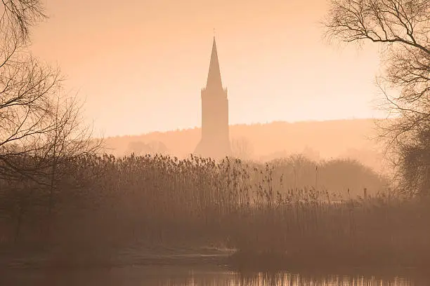 This photo is taken from the shore of a body of water. I used a 70-200mm to capture the churchtower at a respectable distance. The photo is very atmospheric because of the mist and the early morning light. The photo has a mysterious look.