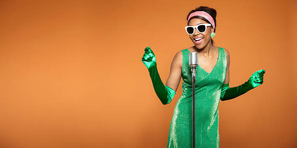 African American woman singing in a green dress and gloves Vintage soul funk woman singing. Black african american. Copy space. black female gospel singers stock pictures, royalty-free photos & images