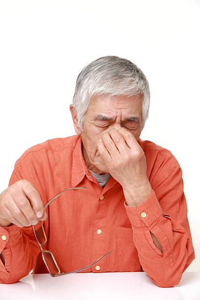 istock senior Japanese man suffers from headache 465297482