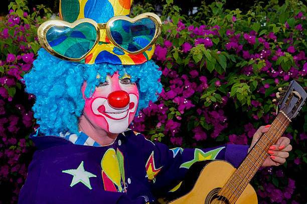 istock Clown with guitar in the park 465297526