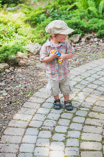 istock Little Boy Smiling Holding Colorful Easter Eggs 465300814