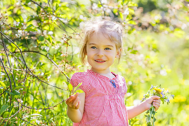 istock Happy little girl in spring sunny park 465301260