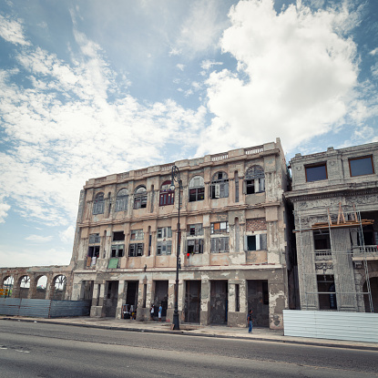 Havana, Cuba - June 7, 2012: Old, partially destroyed building at Malecon street. The building is still inhabited with few tenants.