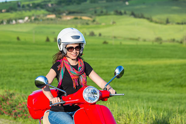 joven mujer viajando por un scooter - motorcycle women helmet sensuality fotografías e imágenes de stock