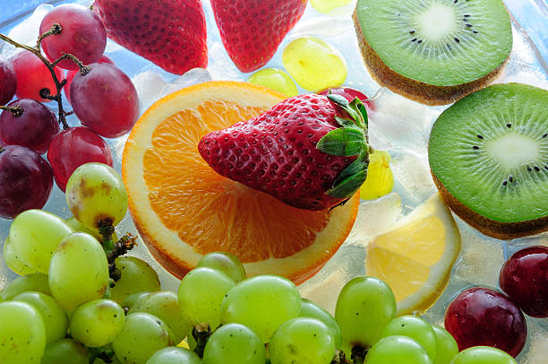 istock juicy fruits on ice 465304170