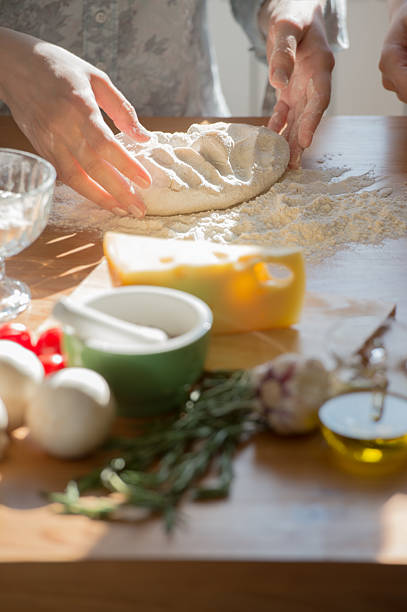 istock A woman making a dough for a pizza at home 465311180