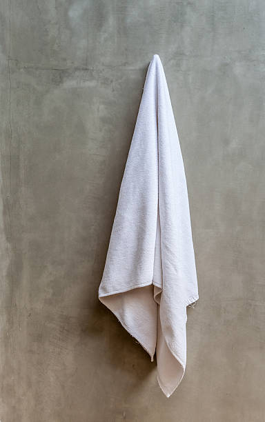 istock White towel is hanging on the exposed concrete wall 465311344