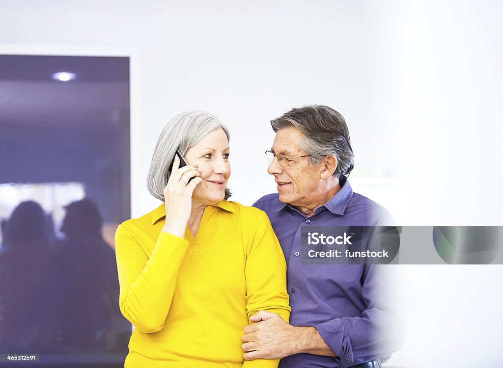 Senior couple using smartphone at home 50-59 Years Stock Photo