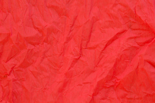 crumpled red crepe paper texture as background
