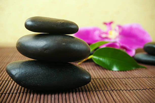 istock Black stones and Orchid 465315190
