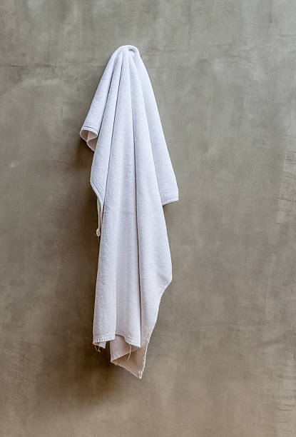 istock The white towel is hanging on hanger with concrete wall 465315258