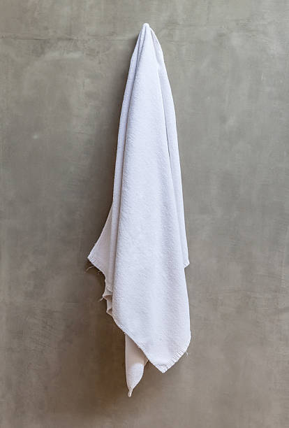 istock The white towel is hanging on hanger with concrete wall 465315270