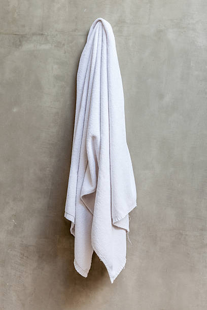 istock White towel is hanging on the exposed concrete wall 465315288