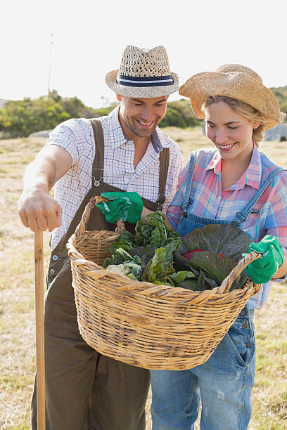 istock Couple with fresh vegetables in field 465317494