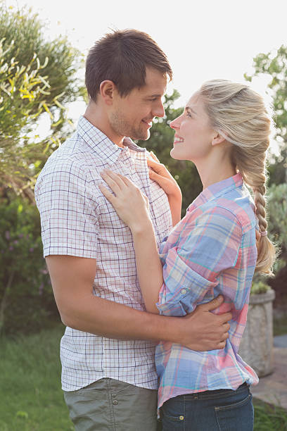 istock Young couple looking at each other against the sky 465317582
