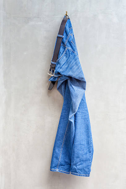 istock Blue jeans with leather belt is hanging on hanger 465317778