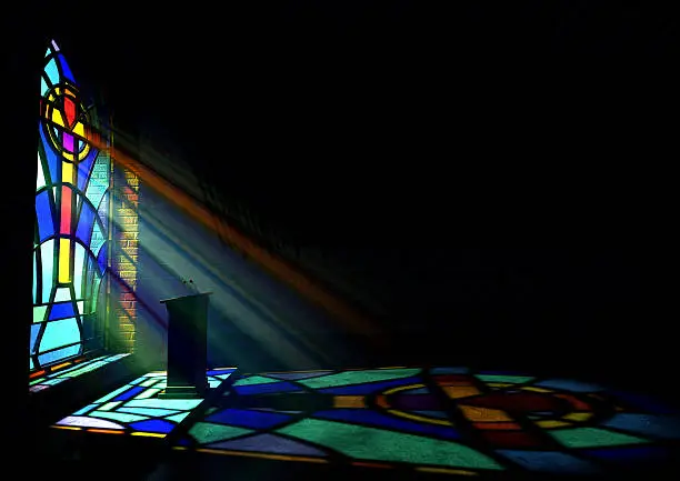 Photo of A reflection from a stained glass window of a church