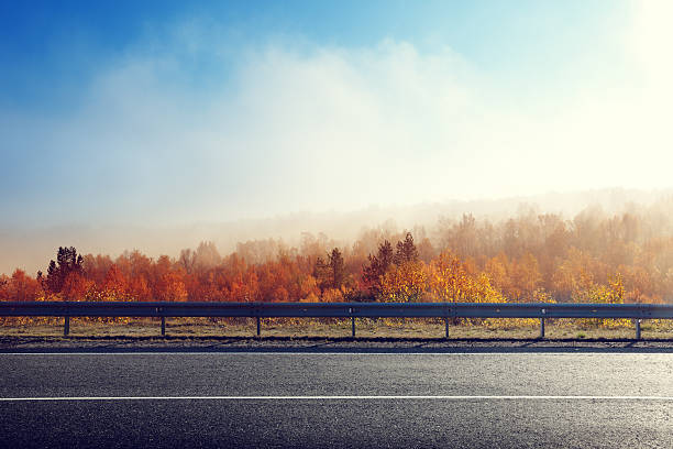 autumn road に日没の時間 - distant field meadow landscape ストックフォトと画像