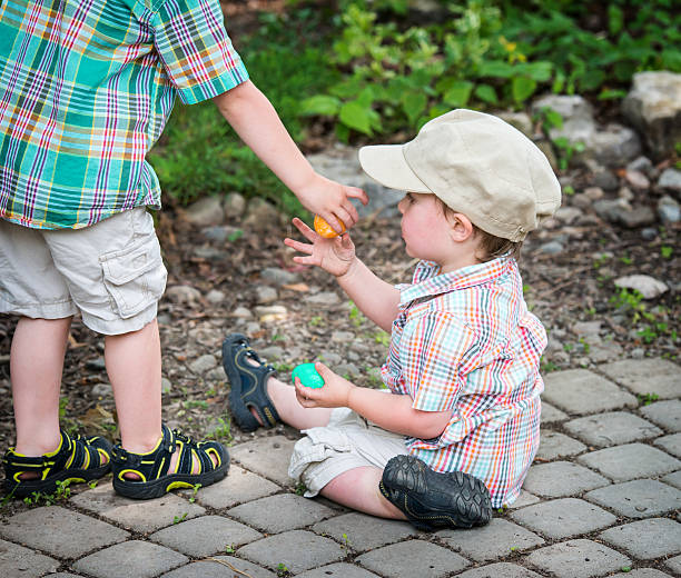 istock Boy Gives Easter Egg to His Little Brother 465319062