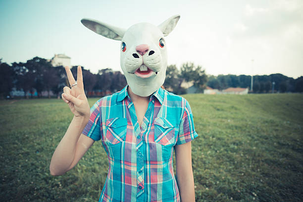 istock rabbit mask absurd beautiful young hipster woman 465319194