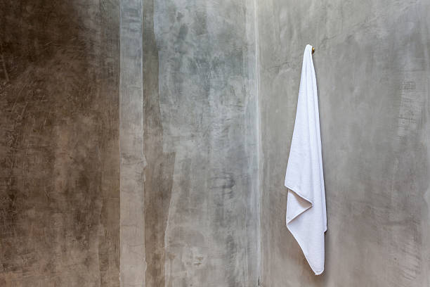 istock White towel is hanging on a hanger with concrete wall 465322040