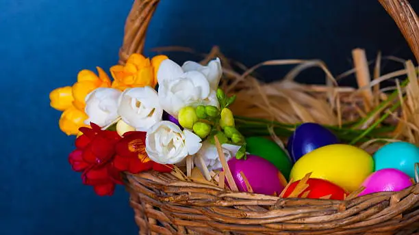 Photo of Easter eggs and freesia in basket