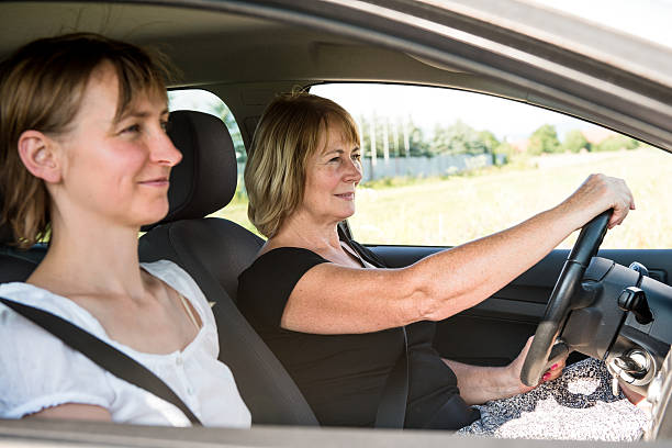 istock Senior woman with daughter driving car 465322877