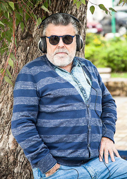 istock Man with beard listening to music 465327682