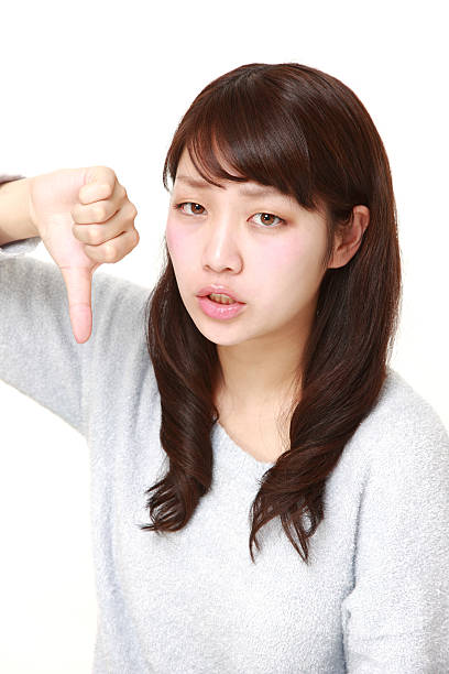 istock woman with thumbs down gesture 465330504