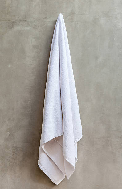 White towel is hanging on the exposed concrete wall