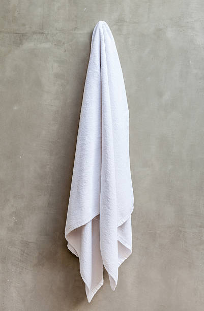 istock Hanging white towel draped on exposed concrete wall 465330844