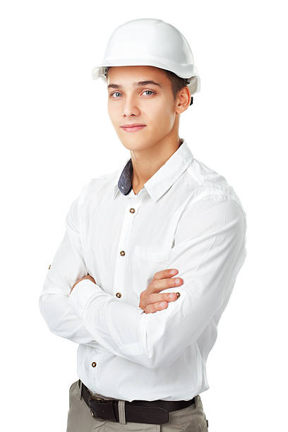 young engineer wearing a white helmet Portrait of young engineer wearing a white helmet standing with hands folded against isolated on white background gray eyes photos stock pictures, royalty-free photos & images