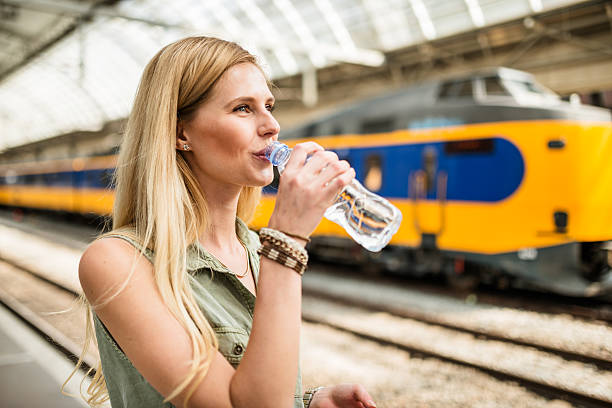 smiling tourist refreshment at the station - trein nederland stockfoto's en -beelden