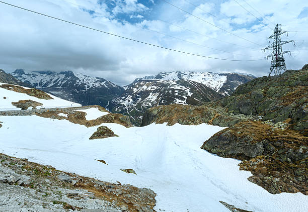 Summer mountain landscape (Grimsel Pass, Switzerland) Summer mountain landscape with road and electric pole (Grimsel Pass, Switzerland) grimsel pass photos stock pictures, royalty-free photos & images