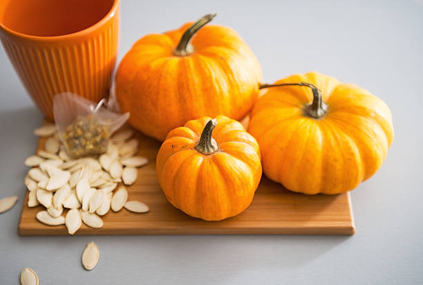 istock Small pumpkins and seeds on table. Closeup 465336262