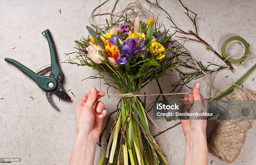 hands of florist making bouquet spring flowers 2015 Stock Photo