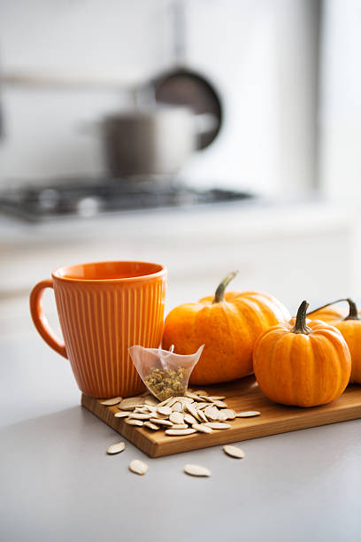 istock Small pumpkins seeds and tea bag on table. Closeup 465339066