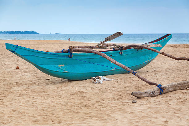 istock Traditional Sri Lankan fishing boat on empty sandy beach. 465339492