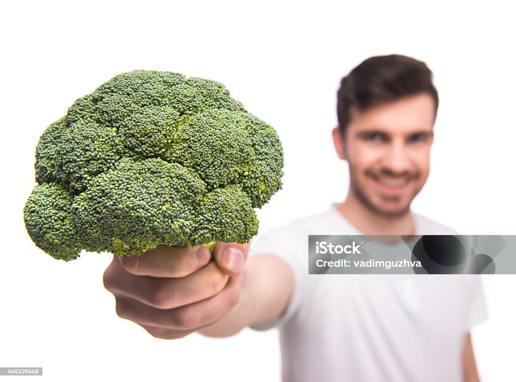 Vegetables Portrait of a handsome man with broccoli, isolated on white. 2015 Stock Photo