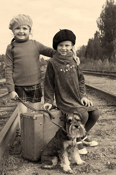istock Two girls and a dog go by rail 465343231