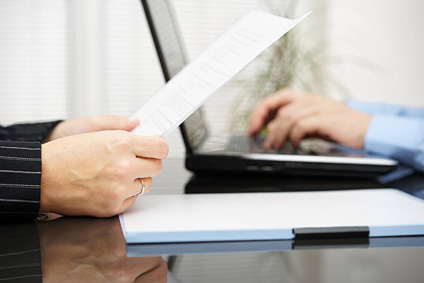 istock Lawyer is reading contract and bussiness client is typing on laptop 465344406
