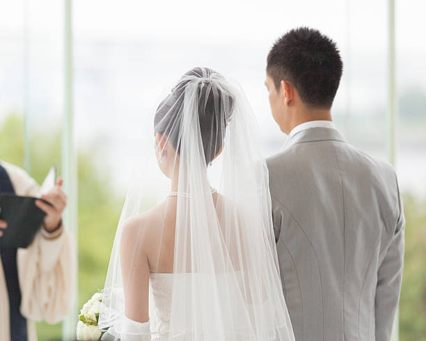 Couple in white wedding ceremony