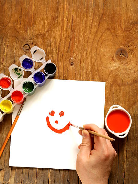 istock painting set - brushes, paints (gouache) on old wooden table 465345043