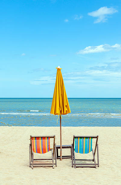 istock Two beach chairs with sun umbrella on beautiful beach. 465345128