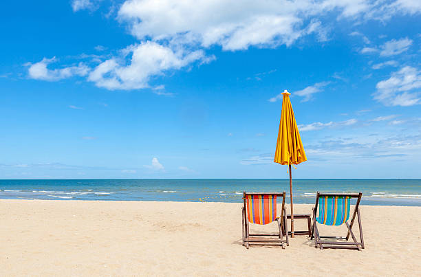 istock Colorful two beach chairs and umbrella on beautiful beach 465345134